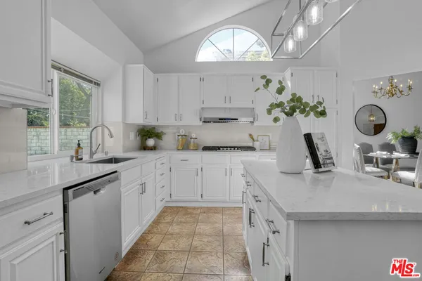 a kitchen with kitchen island white cabinets and white appliances