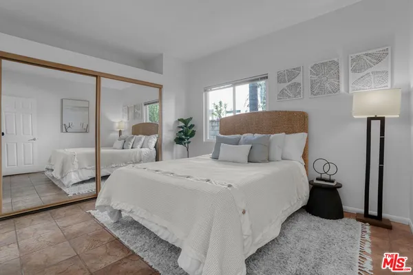 a bedroom with a bed and a lamp