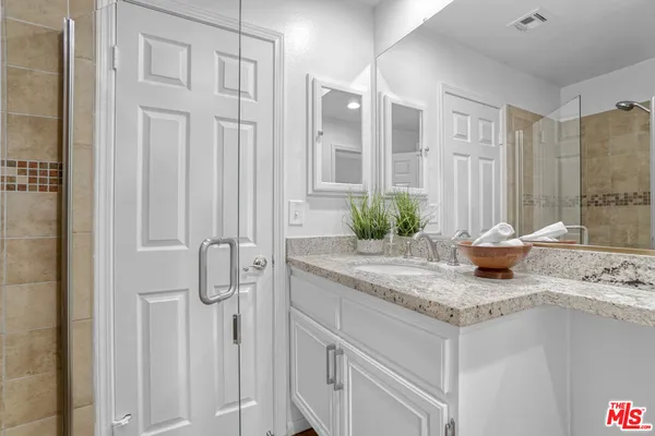 a kitchen with stainless steel appliances granite countertop a sink and a refrigerator