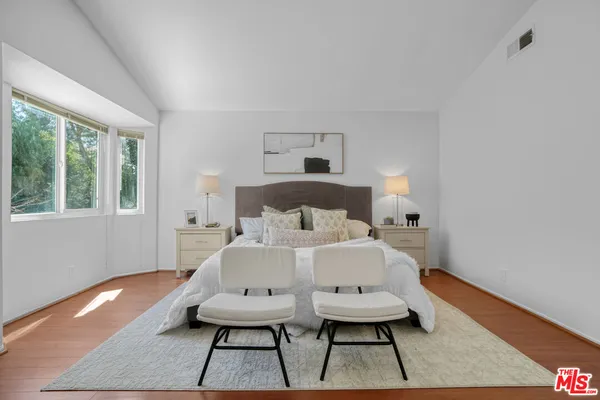 a bed room with a bed a table and a window