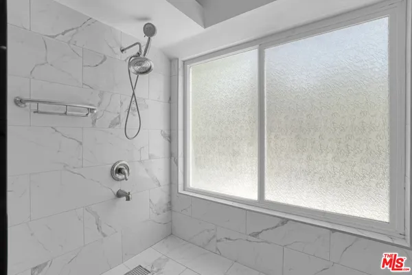 a bathroom with a bathtub and shower