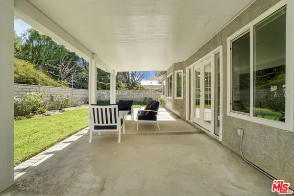 a view of a two chair and table in the patio