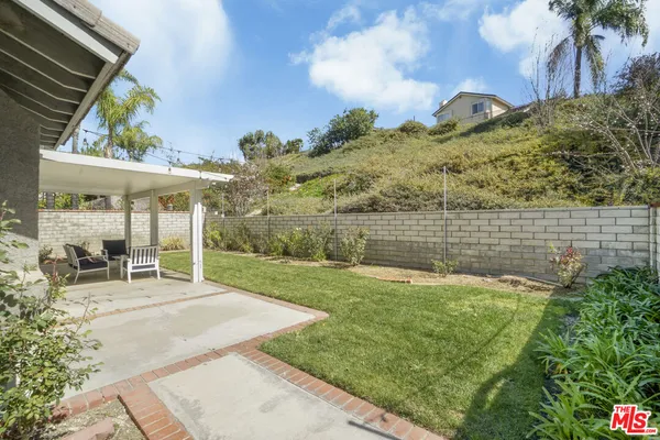 a view of a backyard with a garden and plants