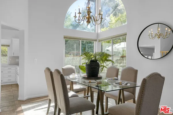 a view of a dining room with furniture and chandelier