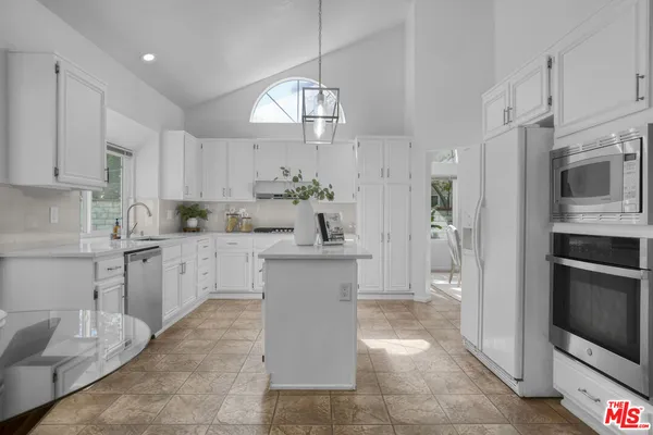 a kitchen with a sink cabinets and stainless steel appliances
