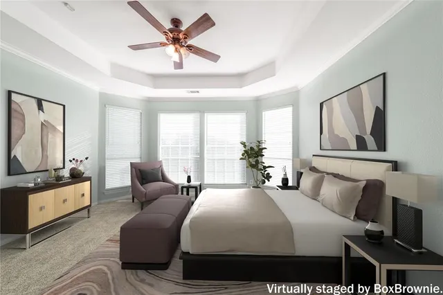 a bedroom with a bed a couch and large window