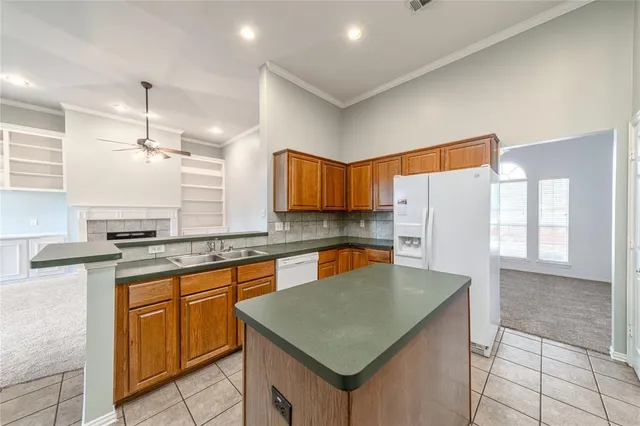 a kitchen with stainless steel appliances granite countertop a sink refrigerator and cabinets