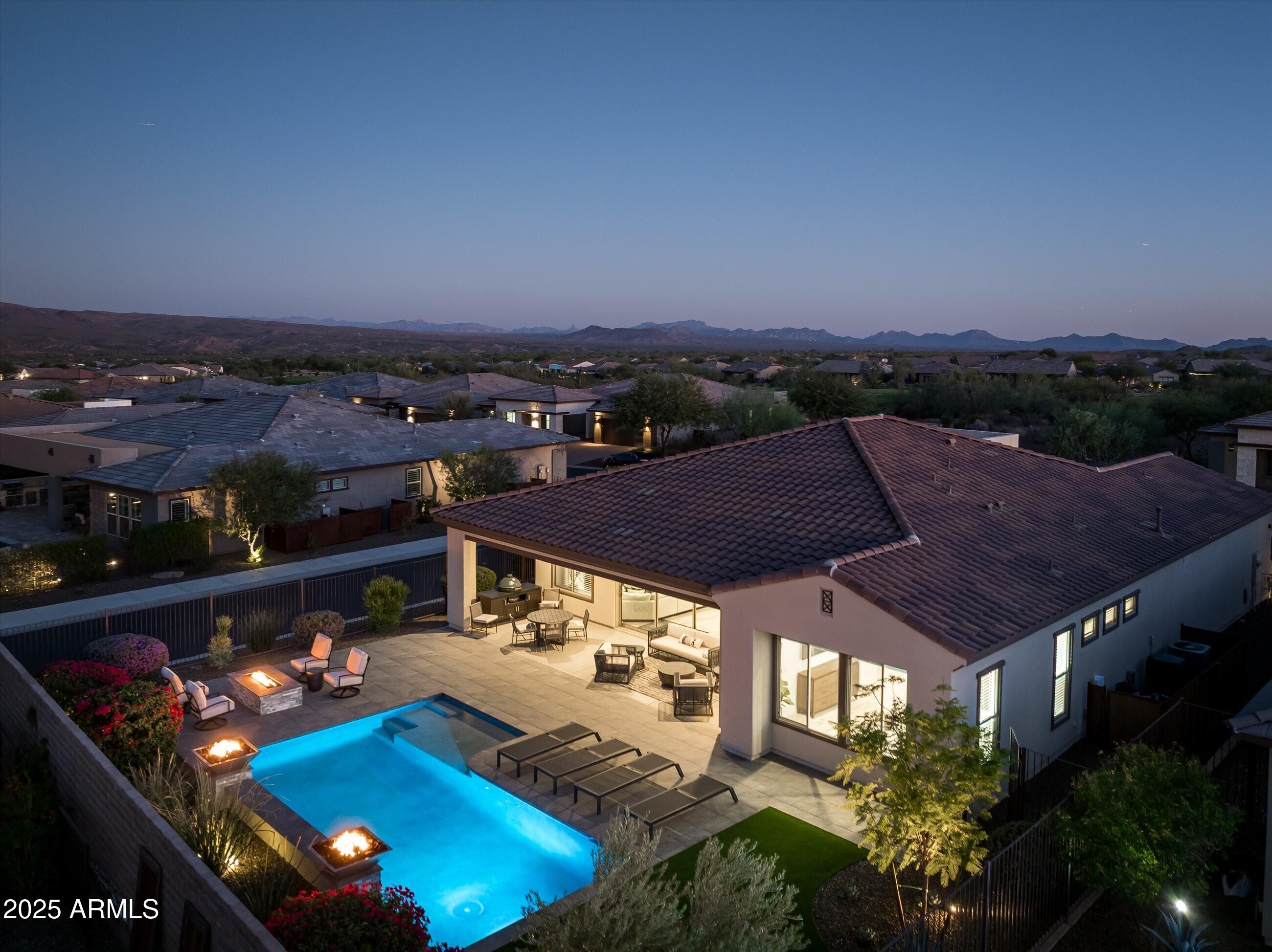 an aerial view of a house with a swimming pool