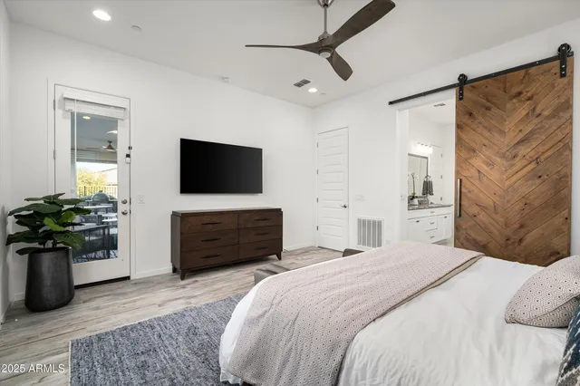 a bedroom with a bed and a flat screen tv