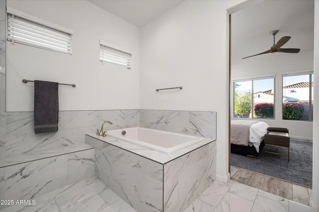a spacious bathroom with a tub and sink