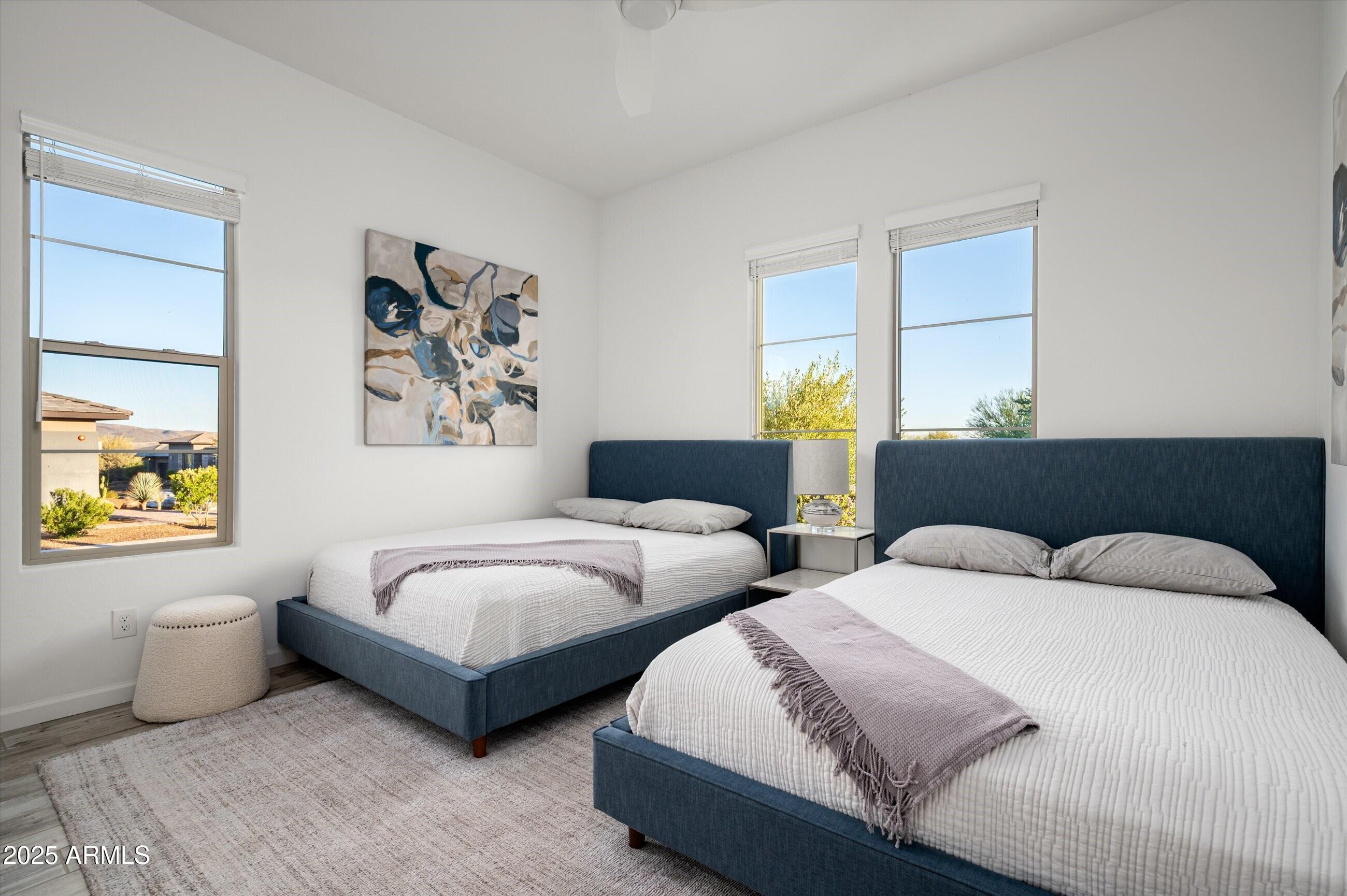 17864 East Veit Springs Drive Rio Verde, AZ 85263 - Photo 19 of 44 a bedroom with two beds and a large window