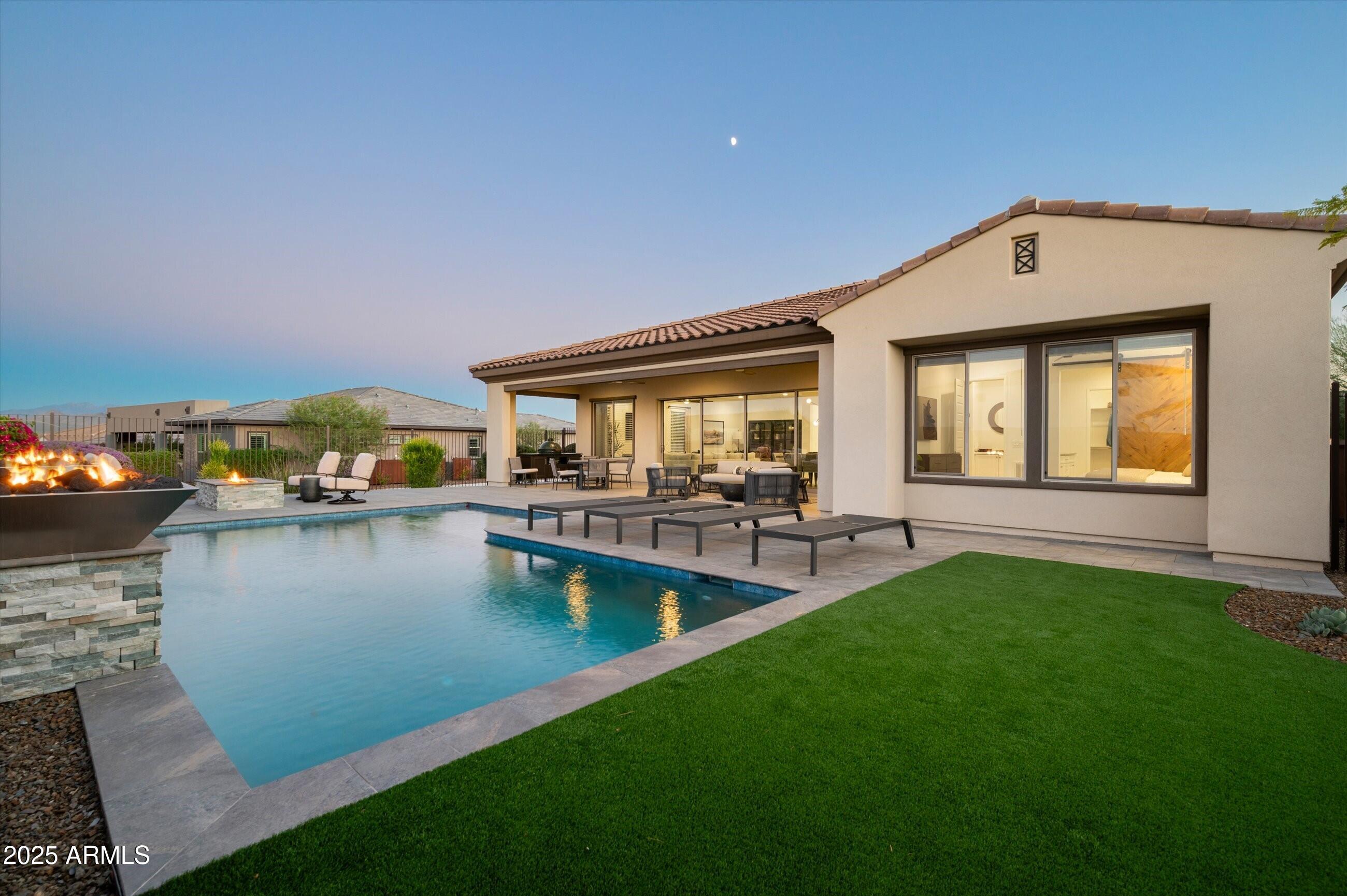 17864 East Veit Springs Drive Rio Verde, AZ 85263 - Photo 27 of 44 a view of a house with swimming pool and a yard