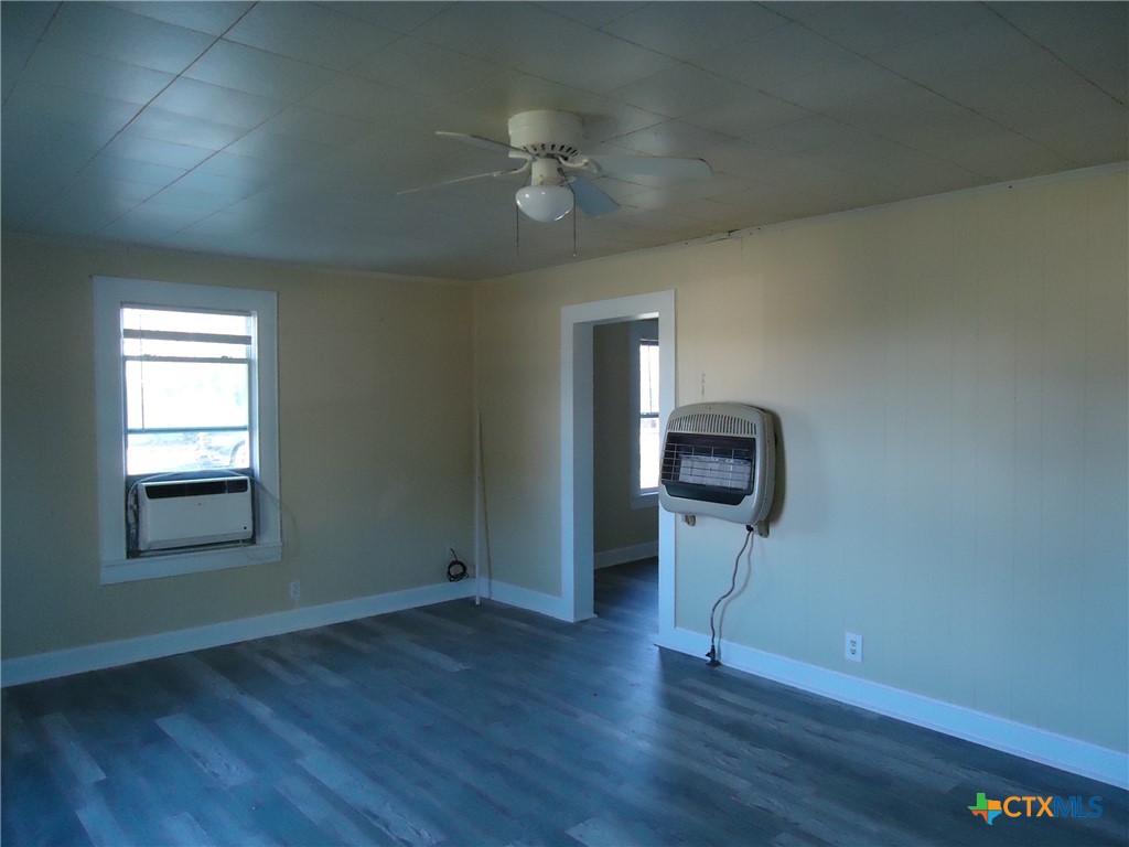 1101 South 33rd Street Temple, TX 76504 - Photo 2 of 8 a view of a livingroom with wooden floor and a ceiling fan
