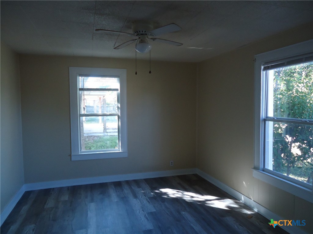 1101 South 33rd Street Temple, TX 76504 - Photo 7 of 8 an empty room with wooden floor and windows