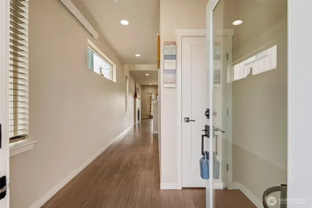 a view of a hallway with wooden floor