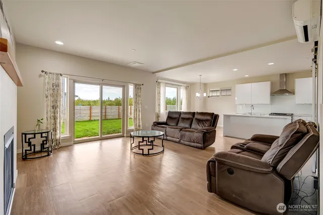 a living room with furniture floor to ceiling window and a floor to ceiling window