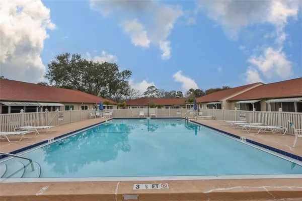 an aerial view of a house with yard swimming pool and outdoor seating