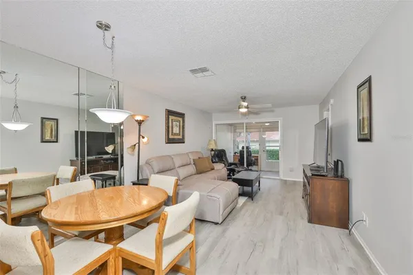 a kitchen with granite countertop white cabinets white stainless steel appliances and a sink