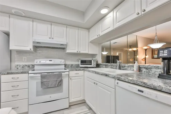 a kitchen with sink cabinets and window