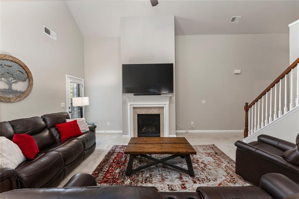 113 Tyson Woods Road Acworth, GA 30102 - Photo 9 of 37 a living room with furniture a flat screen tv and a fireplace
