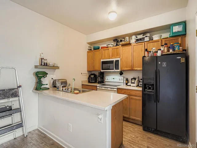 a kitchen with stainless steel appliances a stove refrigerator sink and cabinets