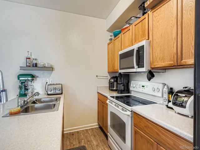 a kitchen with a sink a stove and cabinets