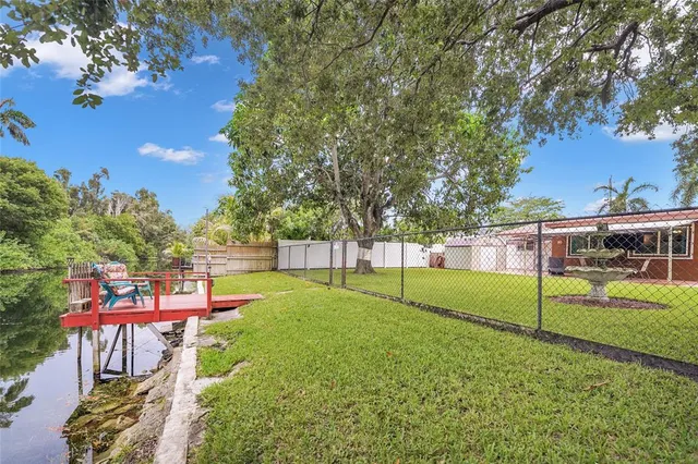 a view of a yard with a house and large trees