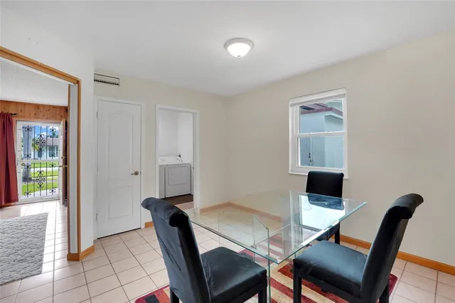 a view of a dining room with furniture and a window