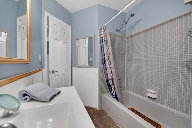 a bathroom with a tub sink and shower