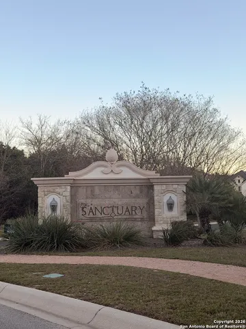 a view of a house with a garden and pathway