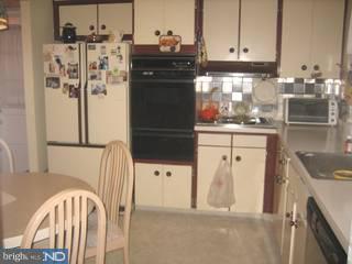 1205 Greenhill Road Flourtown, PA 19031 - Photo 2 of 6 a kitchen with a refrigerator and cabinets