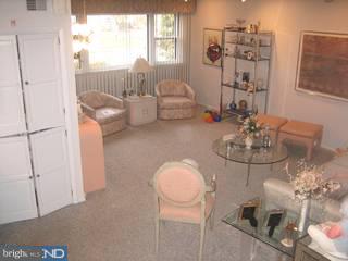 1205 Greenhill Road Flourtown, PA 19031 - Photo 3 of 6 a living room with furniture and a chandelier