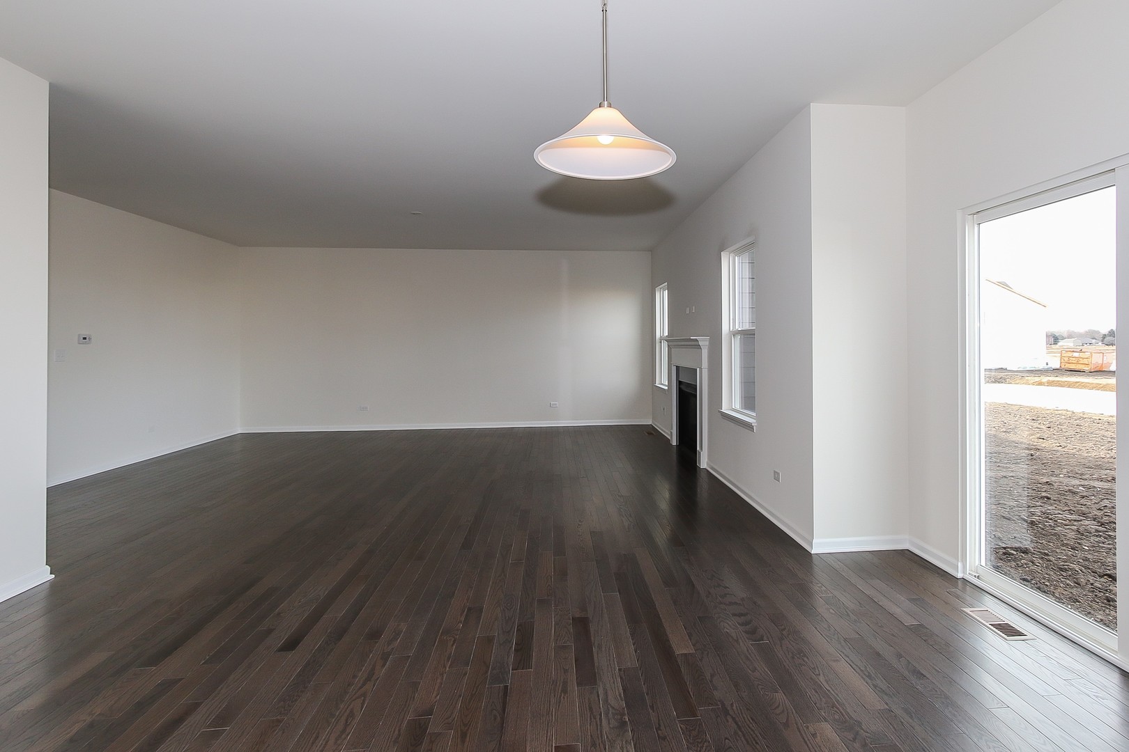 1309 Endicott Road South Elgin, IL 60177 - Photo 11 of 29 an empty room with wooden floor and windows