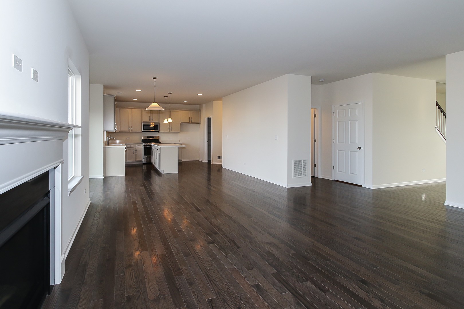 1309 Endicott Road South Elgin, IL 60177 - Photo 14 of 29 a view of a room with wooden floor a fireplace and windows