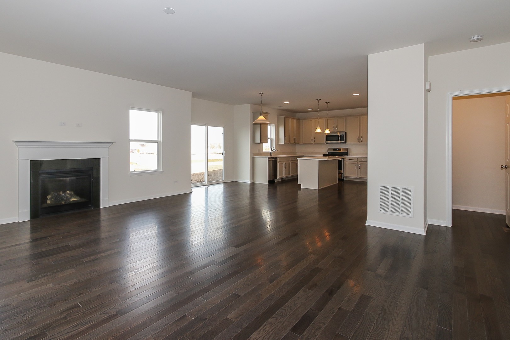 1309 Endicott Road South Elgin, IL 60177 - Photo 15 of 29 a view of an empty room with wooden floor and a fireplace