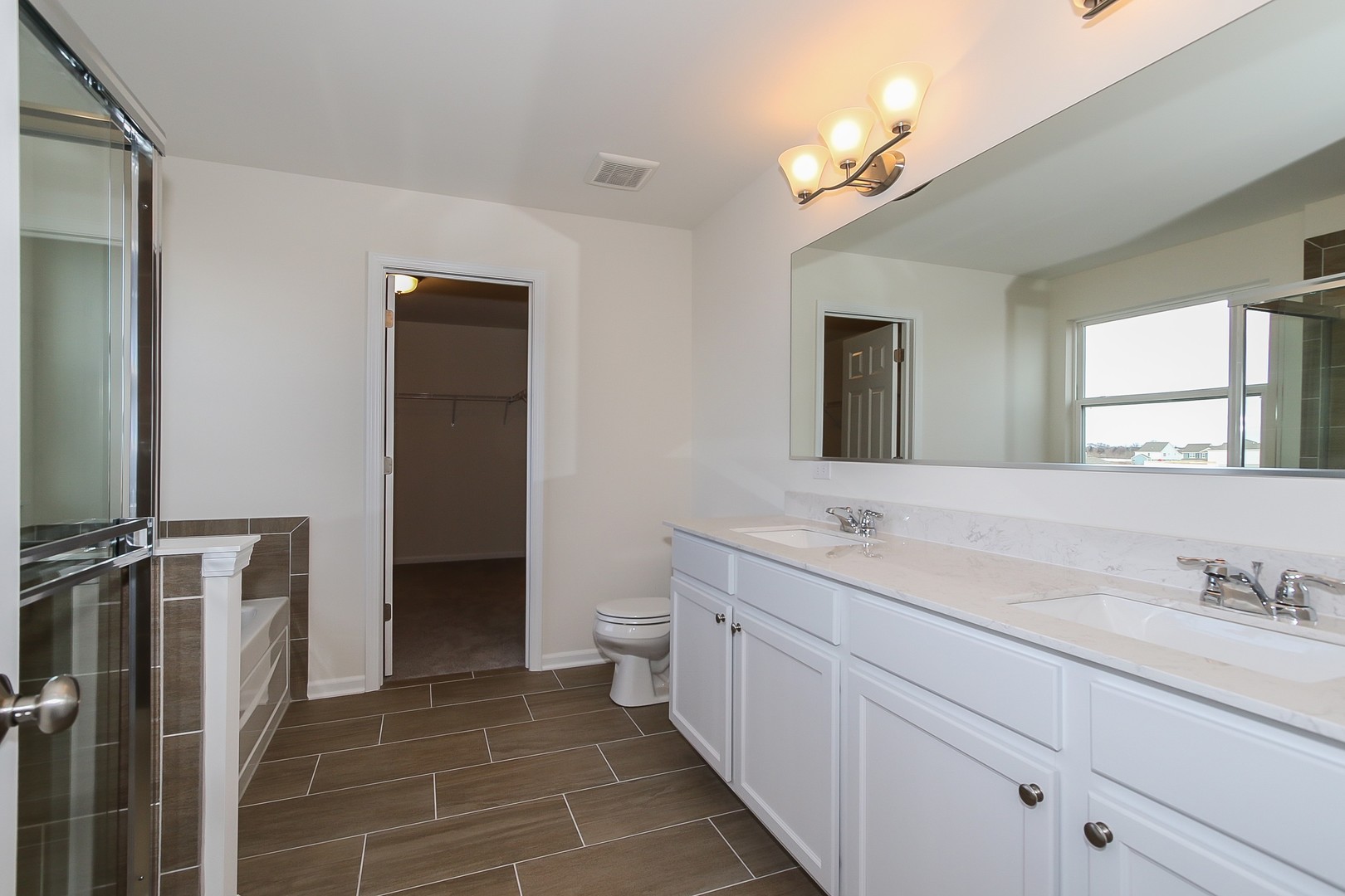 1309 Endicott Road South Elgin, IL 60177 - Photo 21 of 29 a bathroom with a double vanity sink mirror and toilet