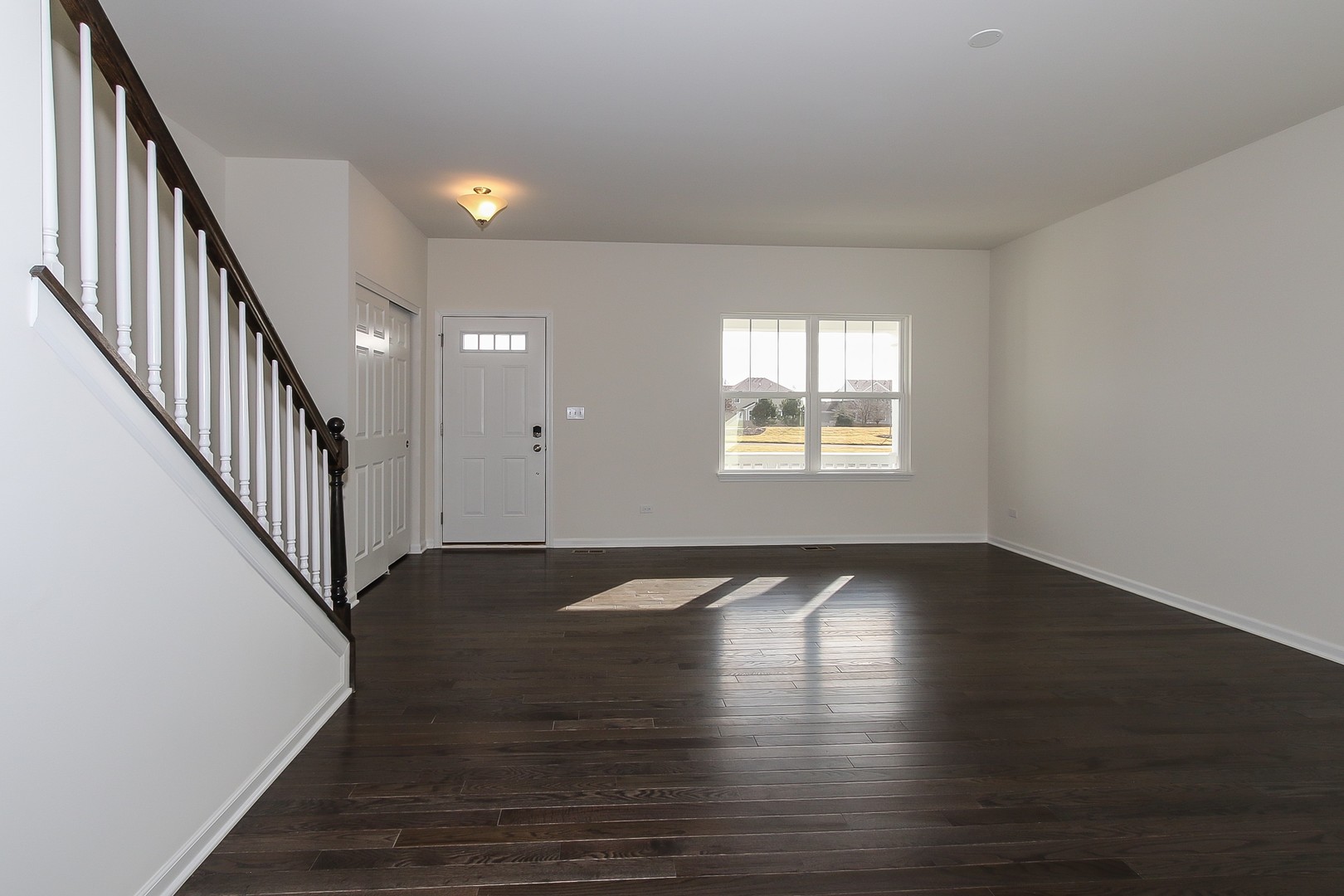1309 Endicott Road South Elgin, IL 60177 - Photo 3 of 29 wooden floor in an empty room with wooden floor and a window