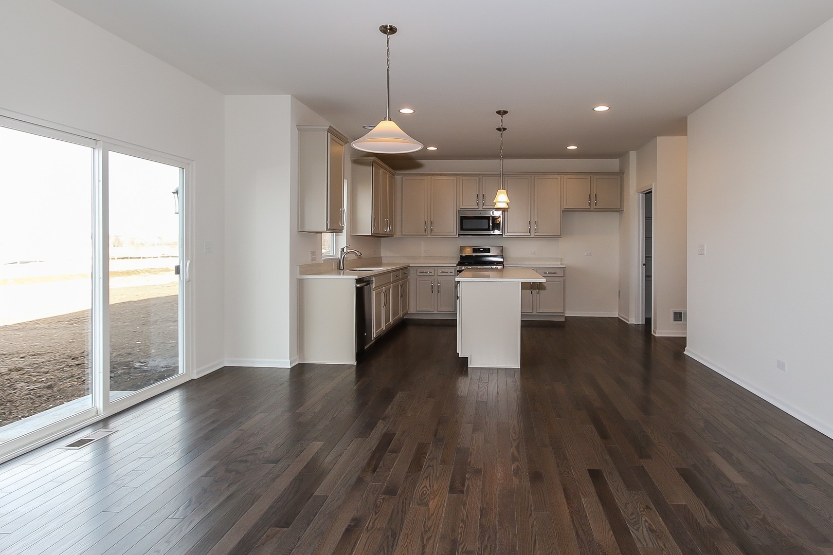 1309 Endicott Road South Elgin, IL 60177 - Photo 5 of 29 a view of a kitchen with stainless steel appliances granite countertop a stove a sink a refrigerator white cabinets and wooden floor