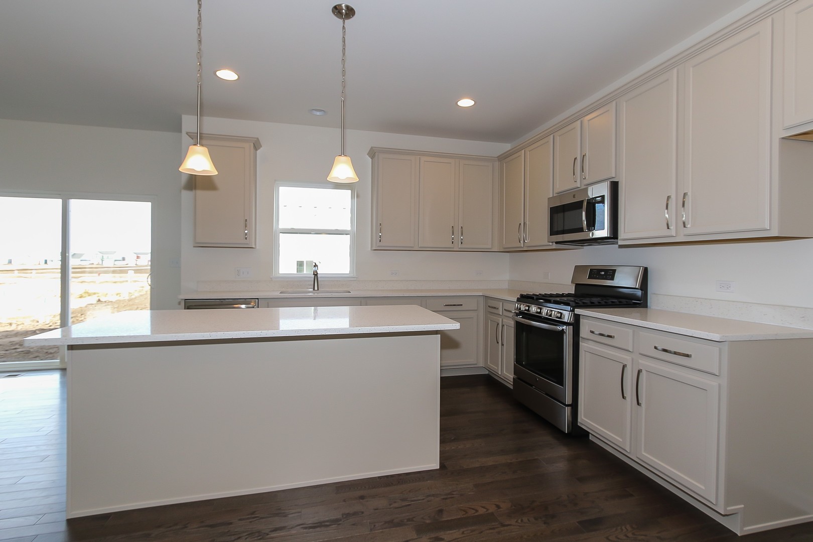 1309 Endicott Road South Elgin, IL 60177 - Photo 7 of 29 a kitchen with stainless steel appliances granite countertop a sink a stove a microwave a center island and a window