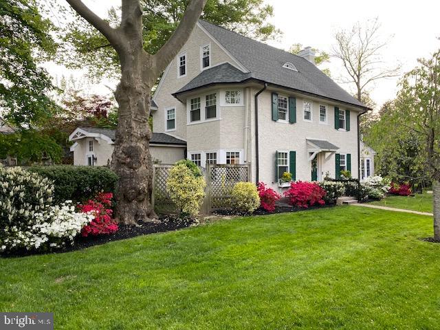 a front view of house with yard and green space