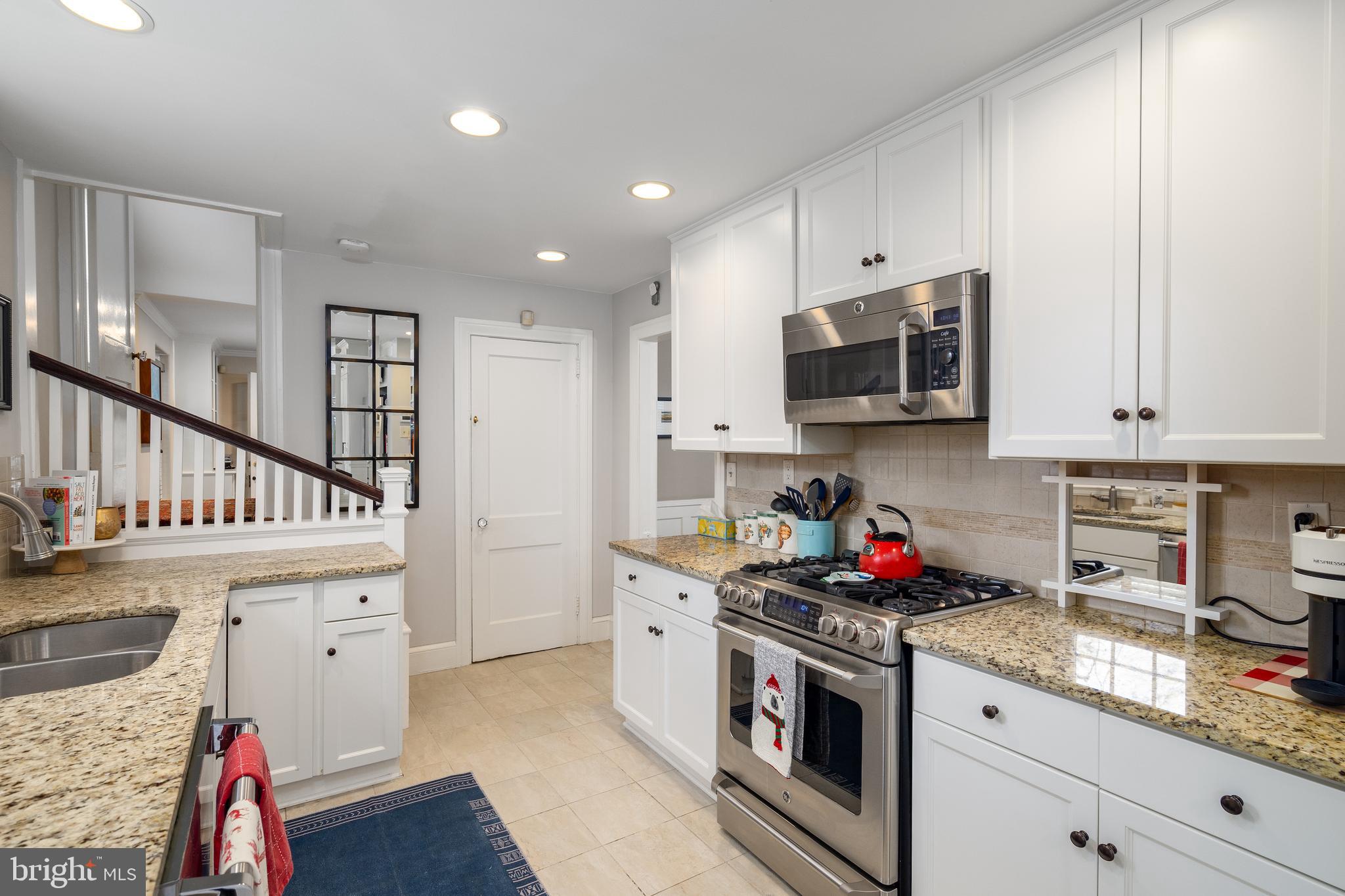 676 Glenmary Road Wayne, PA 19087 - Photo 11 of 38 a kitchen with granite countertop white cabinets and white appliances