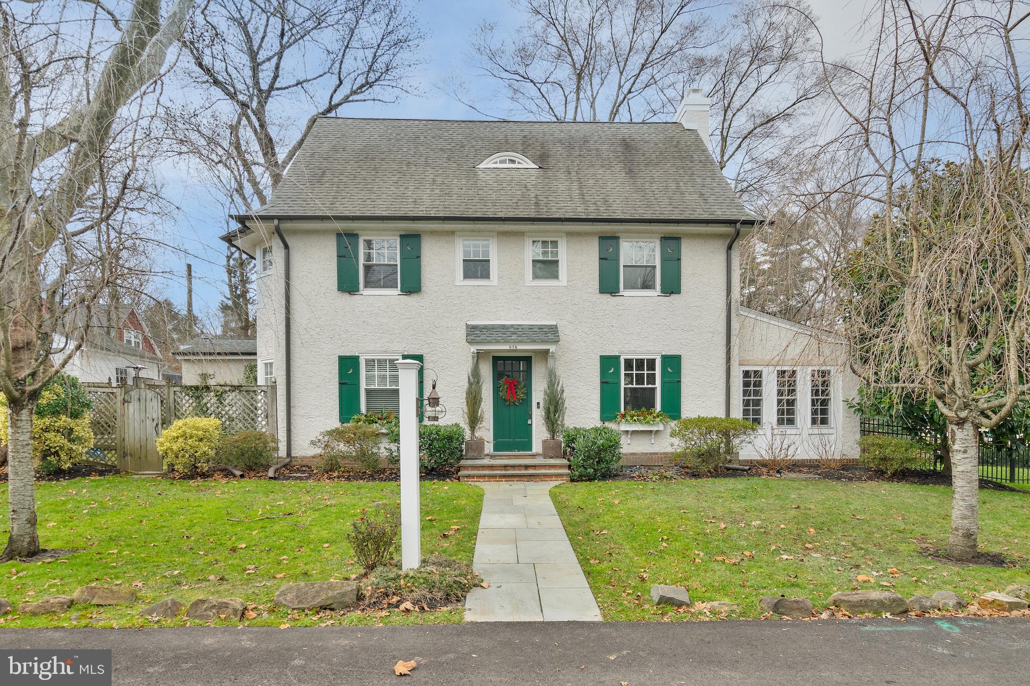 676 Glenmary Road Wayne, PA 19087 - Photo 2 of 38 a front view of a house with a garden and plants