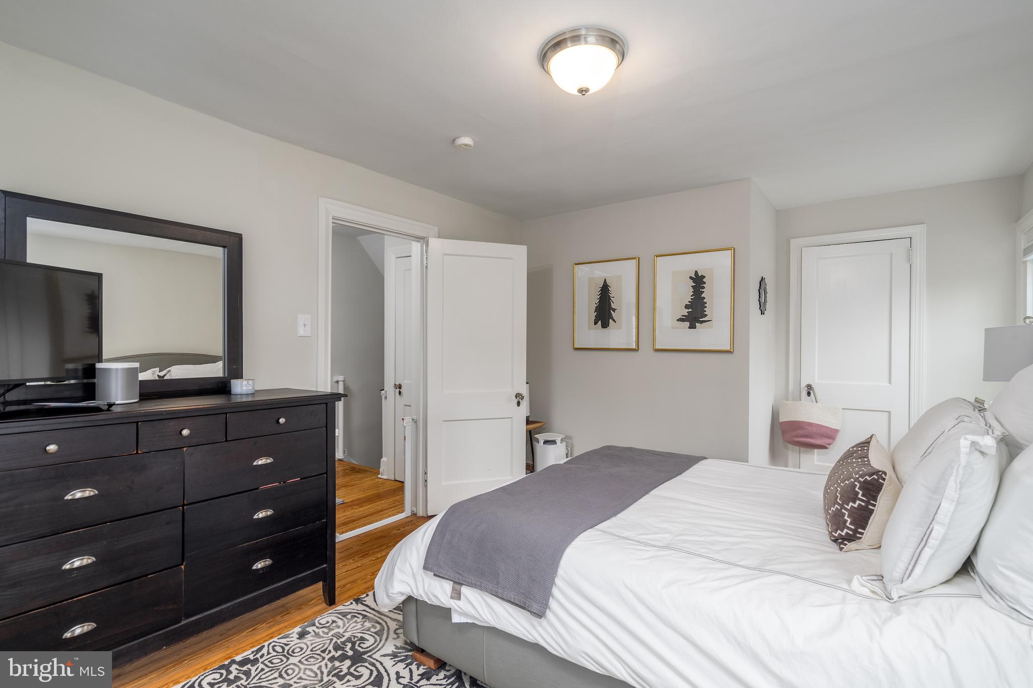 676 Glenmary Road Wayne, PA 19087 - Photo 23 of 38 a bedroom with a bed and a mirror on dresser