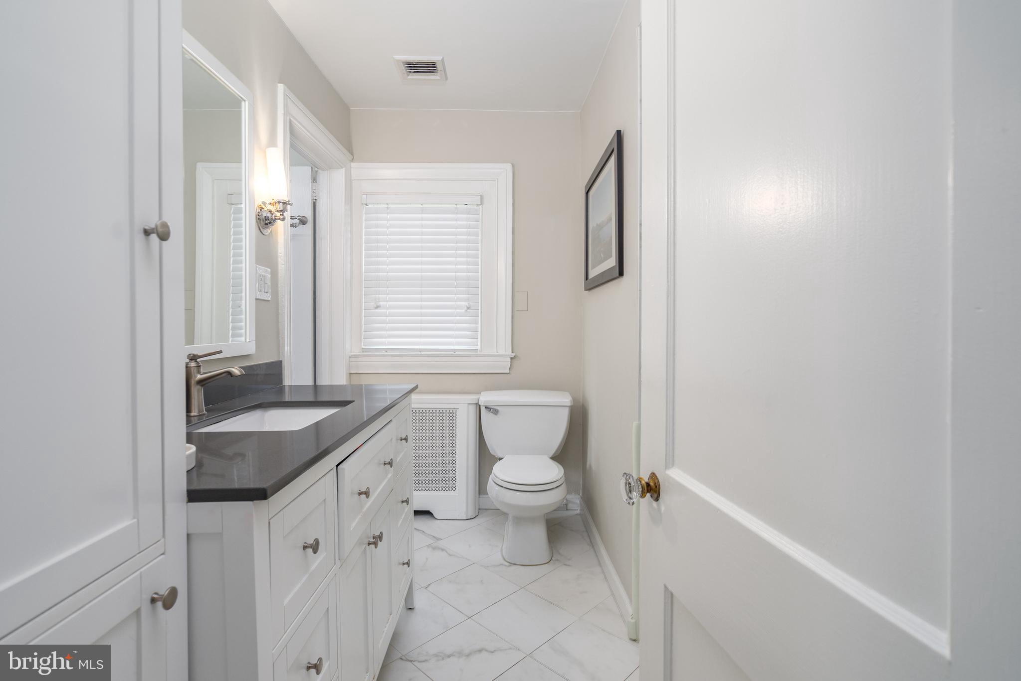 676 Glenmary Road Wayne, PA 19087 - Photo 26 of 38 a bathroom with a granite countertop sink toilet and shower