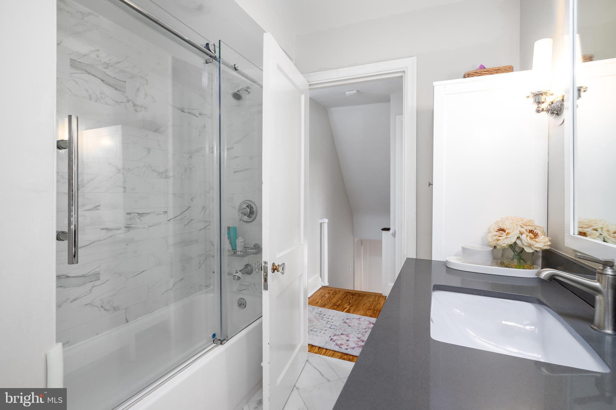 676 Glenmary Road Wayne, PA 19087 - Photo 27 of 38 a bathroom with a tub shower sink and vanity