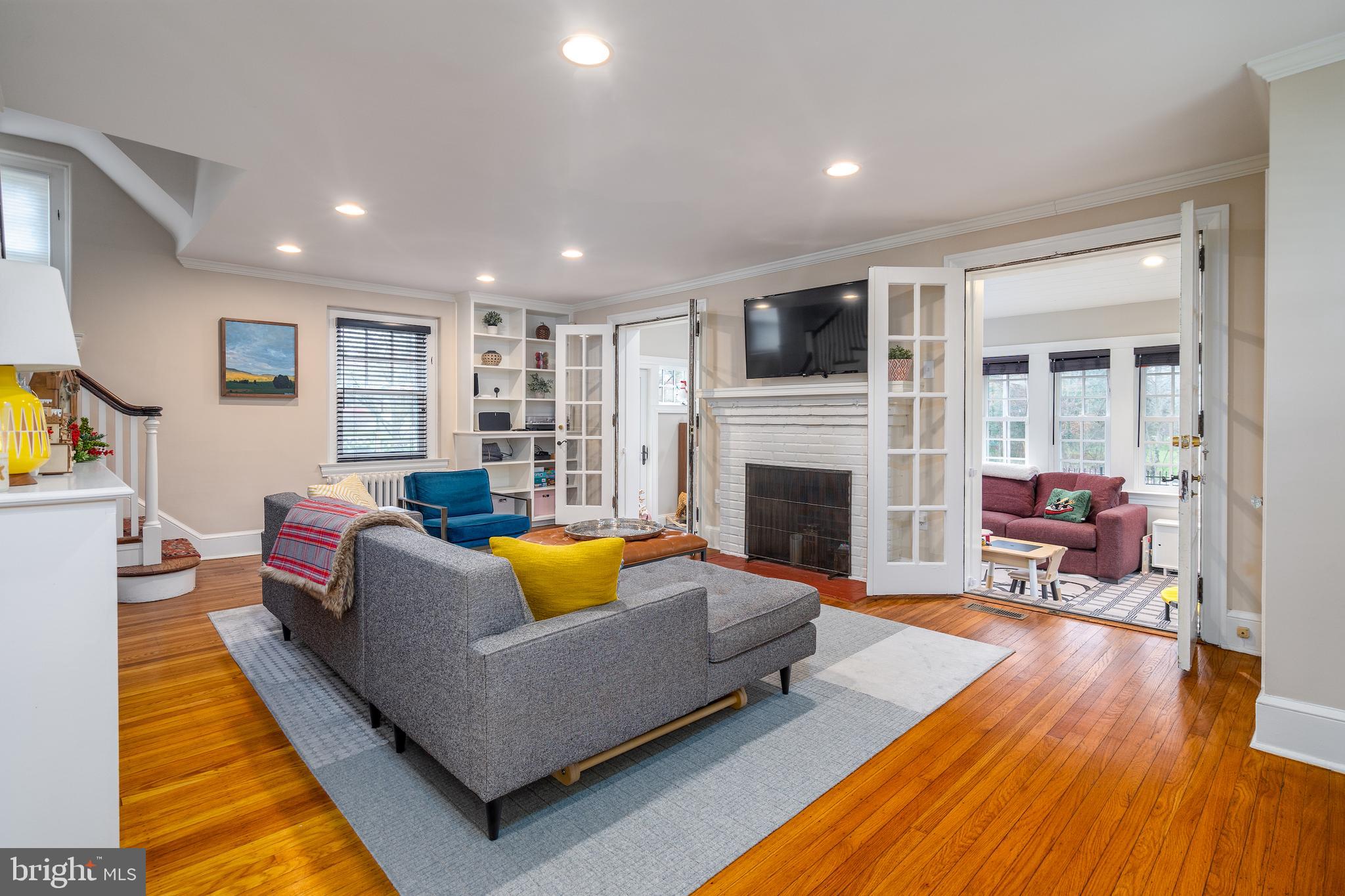 676 Glenmary Road Wayne, PA 19087 - Photo 3 of 38 a living room with furniture fireplace and a flat screen tv