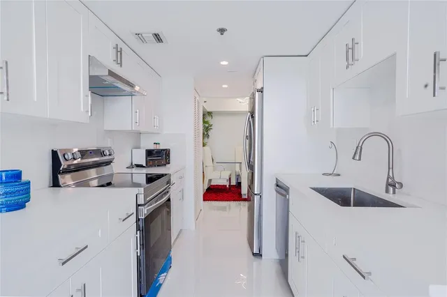 a kitchen with refrigerator and cabinets