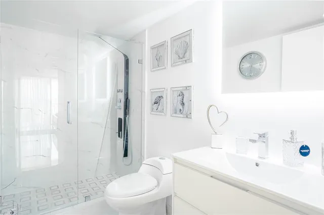 a bathroom with a sink a toilet and shower