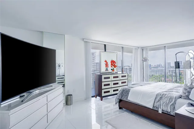 a bedroom with a bed and a flat screen tv