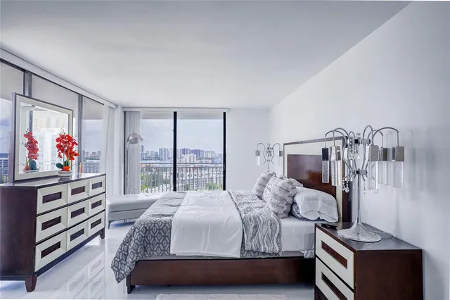 a bedroom with a bed and a painting on the wall